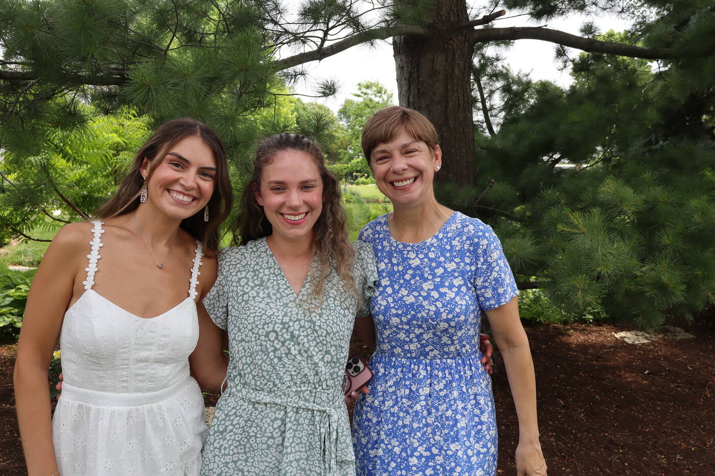 Three guests smiling at a Fiesta Snap event